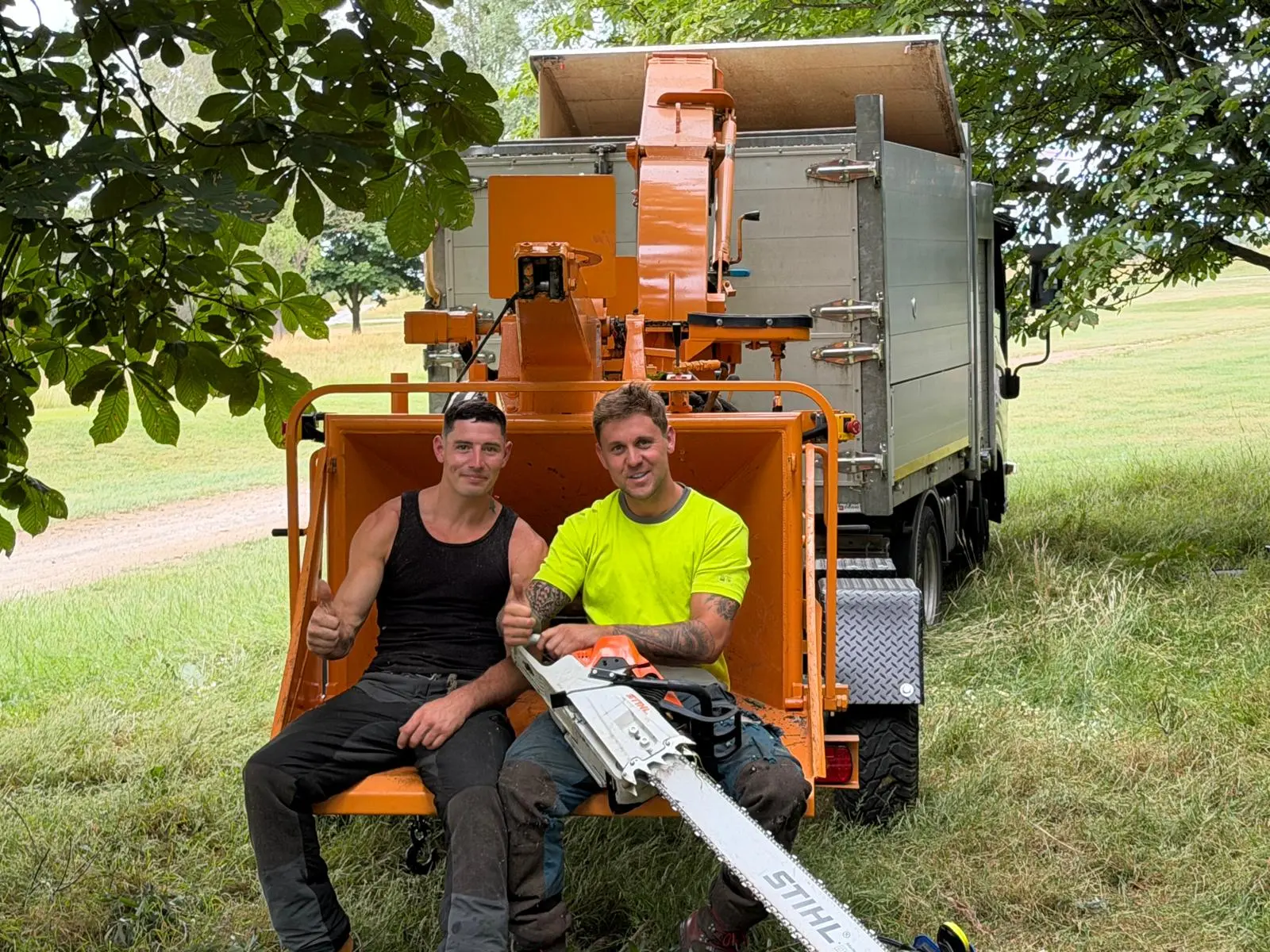 Two of our qualified arborists on site with the chipper and tipper truck